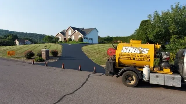 Sheks Sealcoating truck at a residential driveway