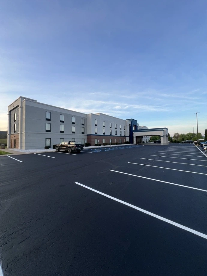 Newly striped commercial parking lot outside an industrial warehouse