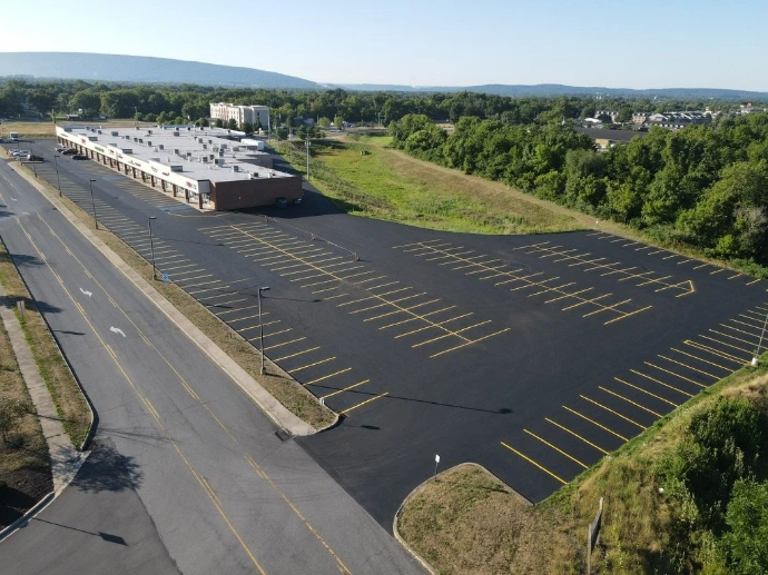 Large commercial parking lot with professional yellow parking space striping