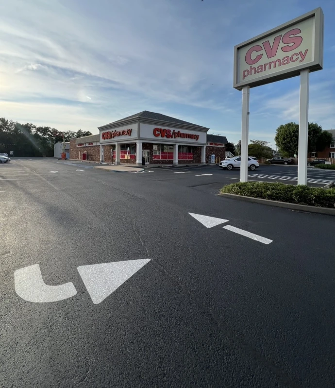 Commercial parking lot with newly striped parking spaces and traffic lanes