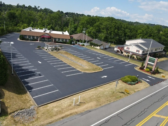Commercial parking lot with bright yellow line striping and traffic flow