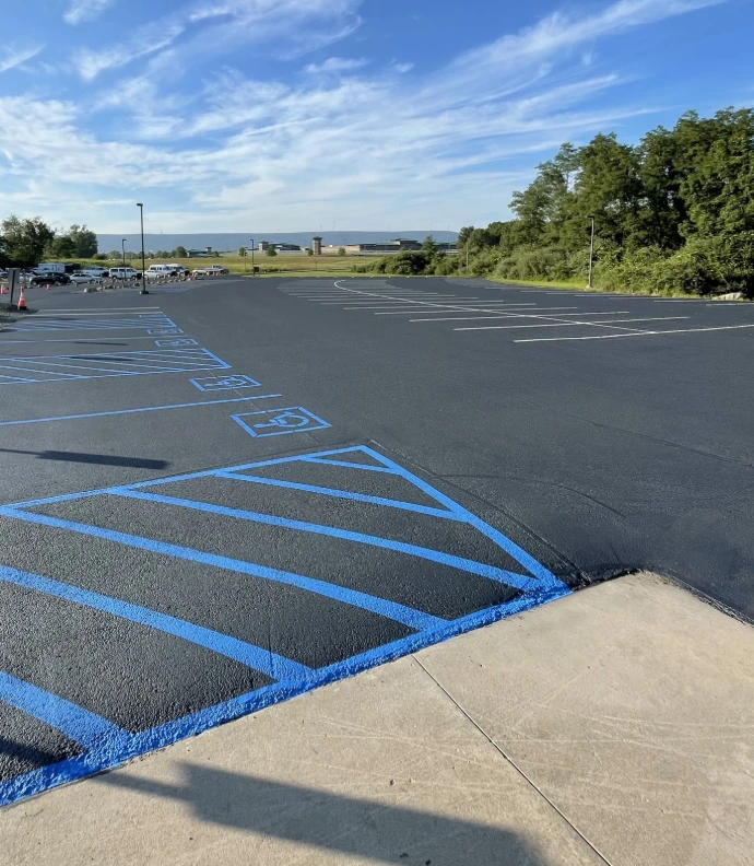 Blue ADA handicap parking spaces with compliant pavement markings