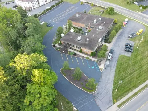 Aerial view of commercial property with newly sealcoated asphalt parking areas