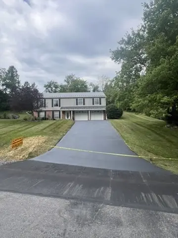 Smooth black asphalt driveway after professional residential sealcoating