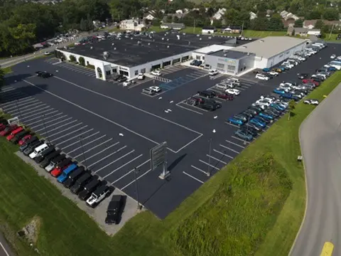 Large commercial parking lot with newly sealcoated asphalt surface