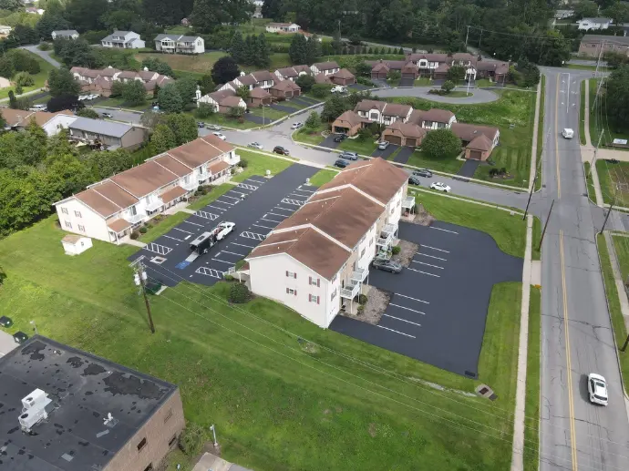 Aerial view of commercial building with professionally sealcoated parking lot
