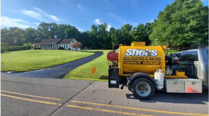 Freshly sealcoated residential driveway with smooth black asphalt finish