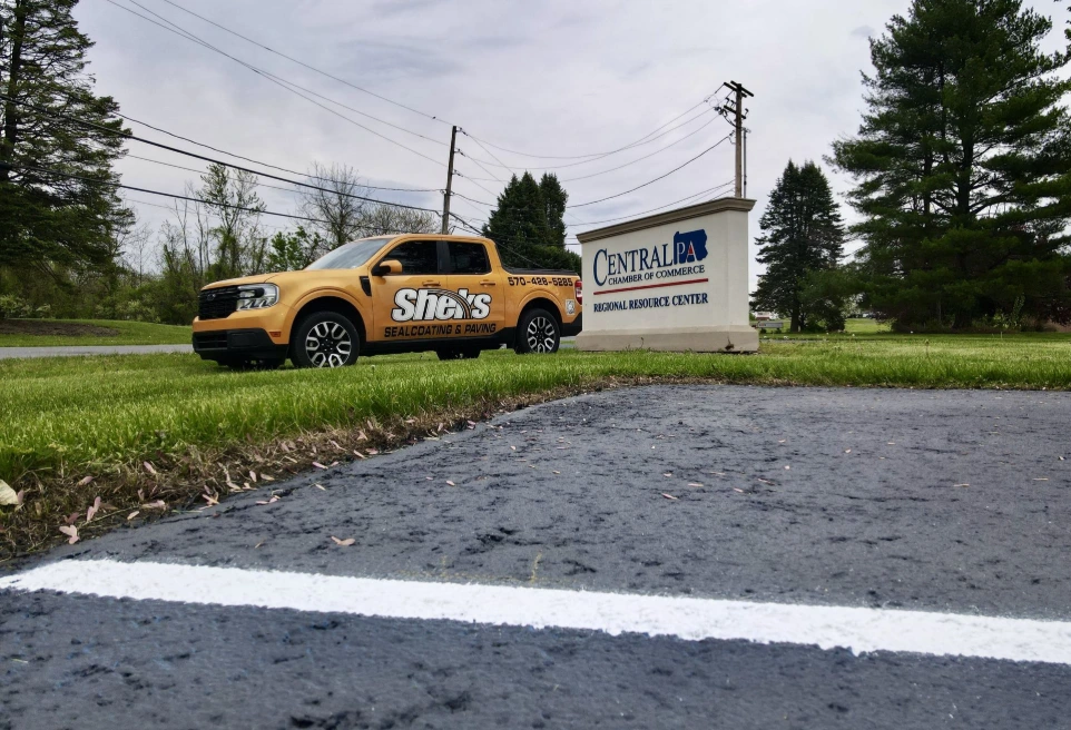 Sheks Sealcoating &amp; Paving company truck parked outside a commercial property