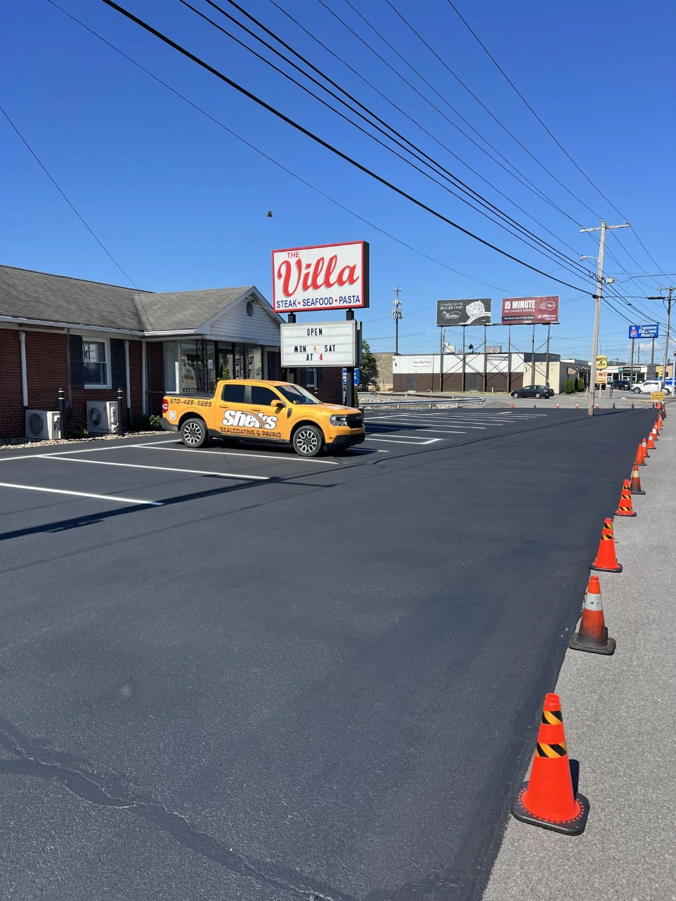 Completed parking lot line striping with bright traffic markings and ADA spaces