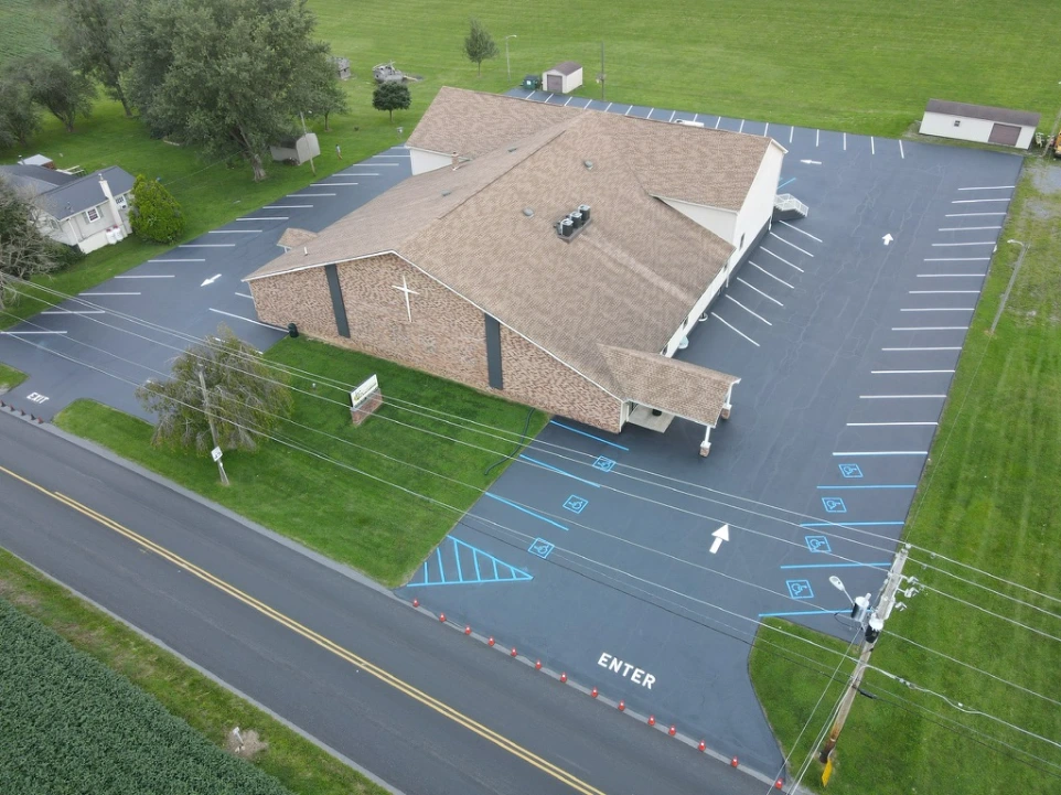 Residential roof and driveway viewed from above after paving improvements